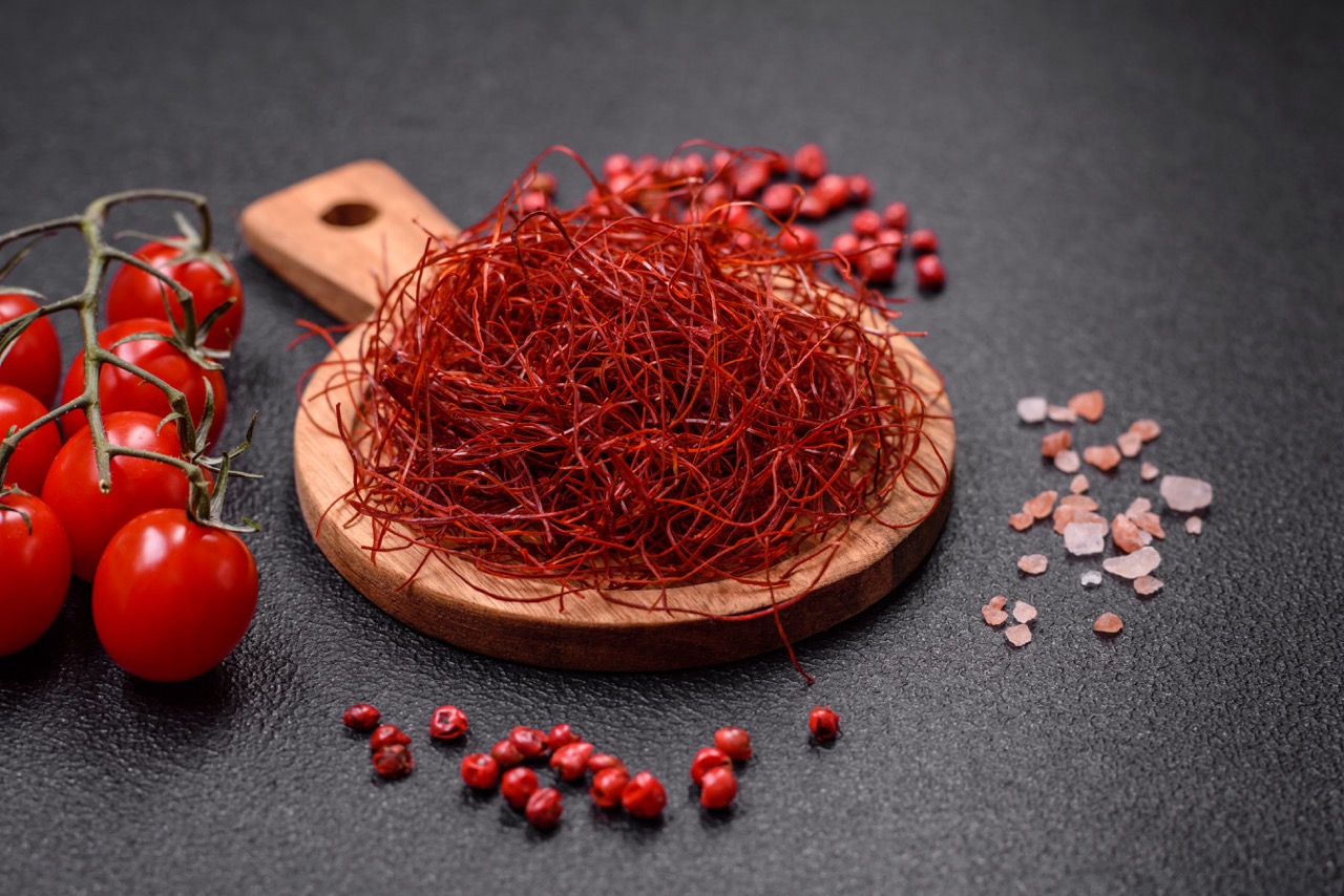 Red thin hot chili threads on a dark background. For decorating Asian dishes